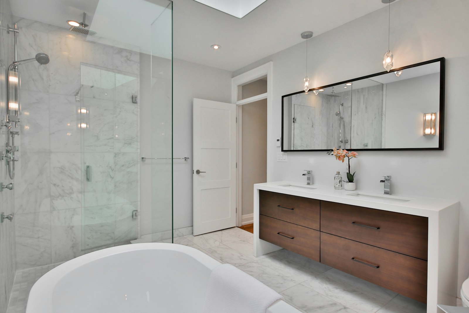 Baño con gres porcelánico de gran formato y grifería empotrada de alta gama